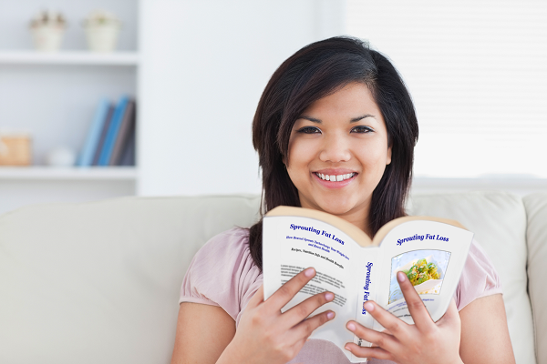 Young woman reading a copy of Sprouting Fat Loss