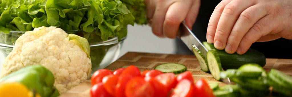 Chopping fresh fruit and vegetables for a healthy meal rich in beneficial nutrients. #healthyeating