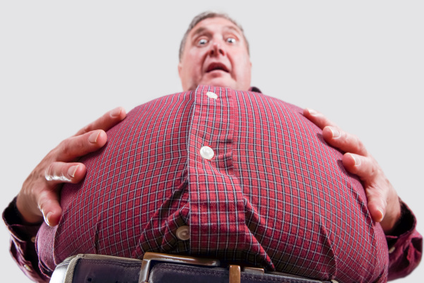Reasons to lose weight - obese male struggling to see below his belly